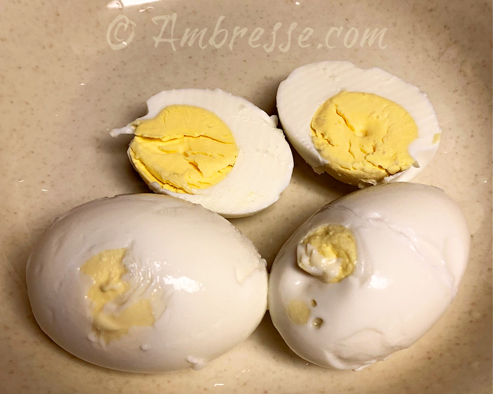 Seven month old waterglassed eggs, hard-boiled. The yolks have drifted to the edge of the eggs. They are delicious, but not pretty.